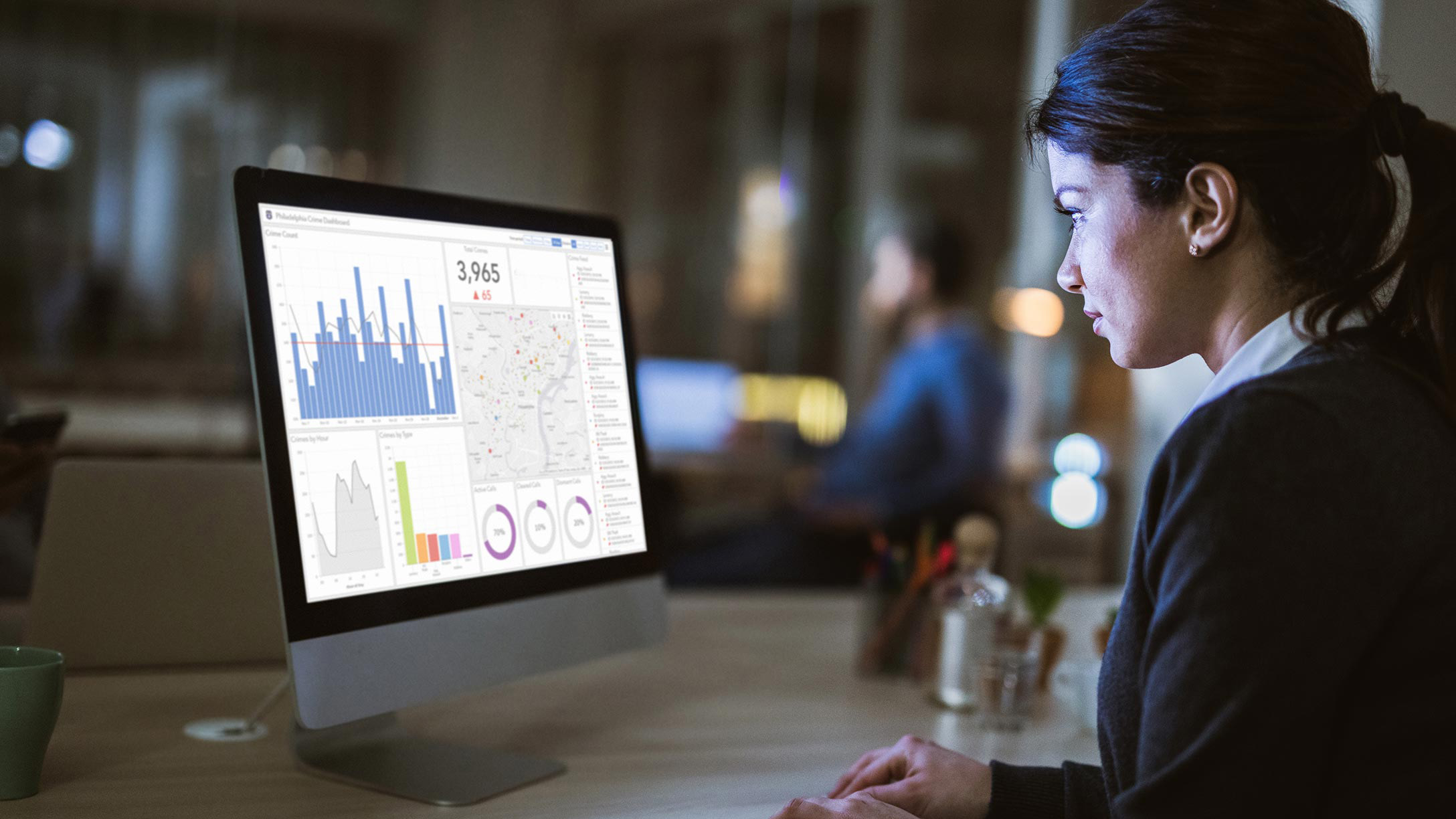 Young woman looking at screen with dashboards