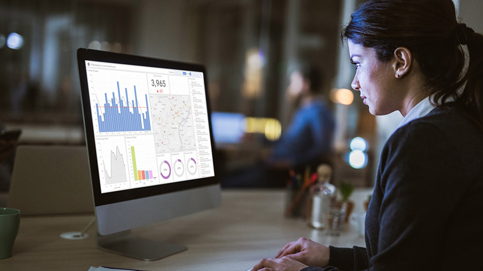 Young woman looking at screen with dashboards