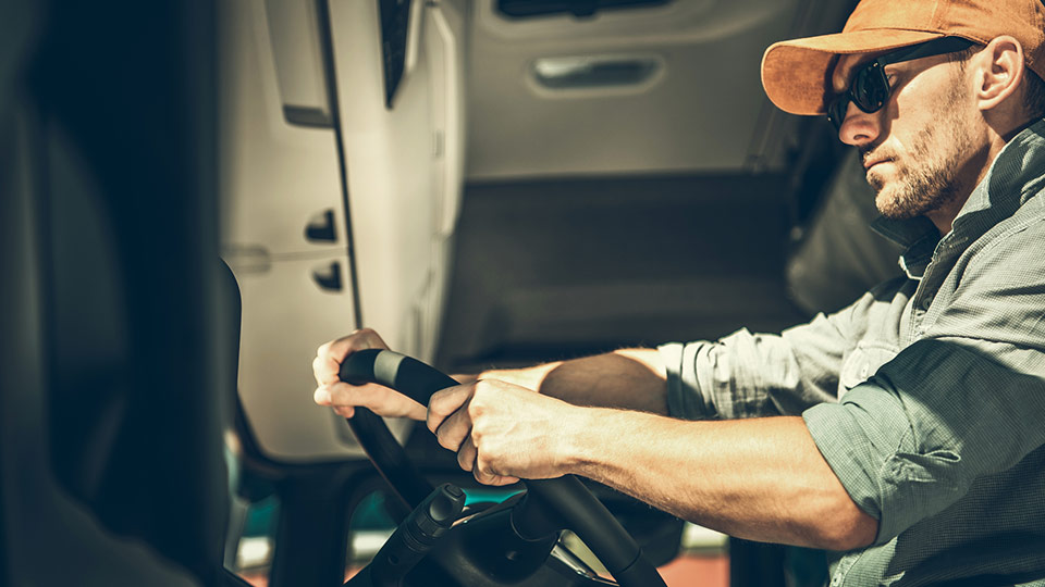 Truck driver with their hand on the wheel