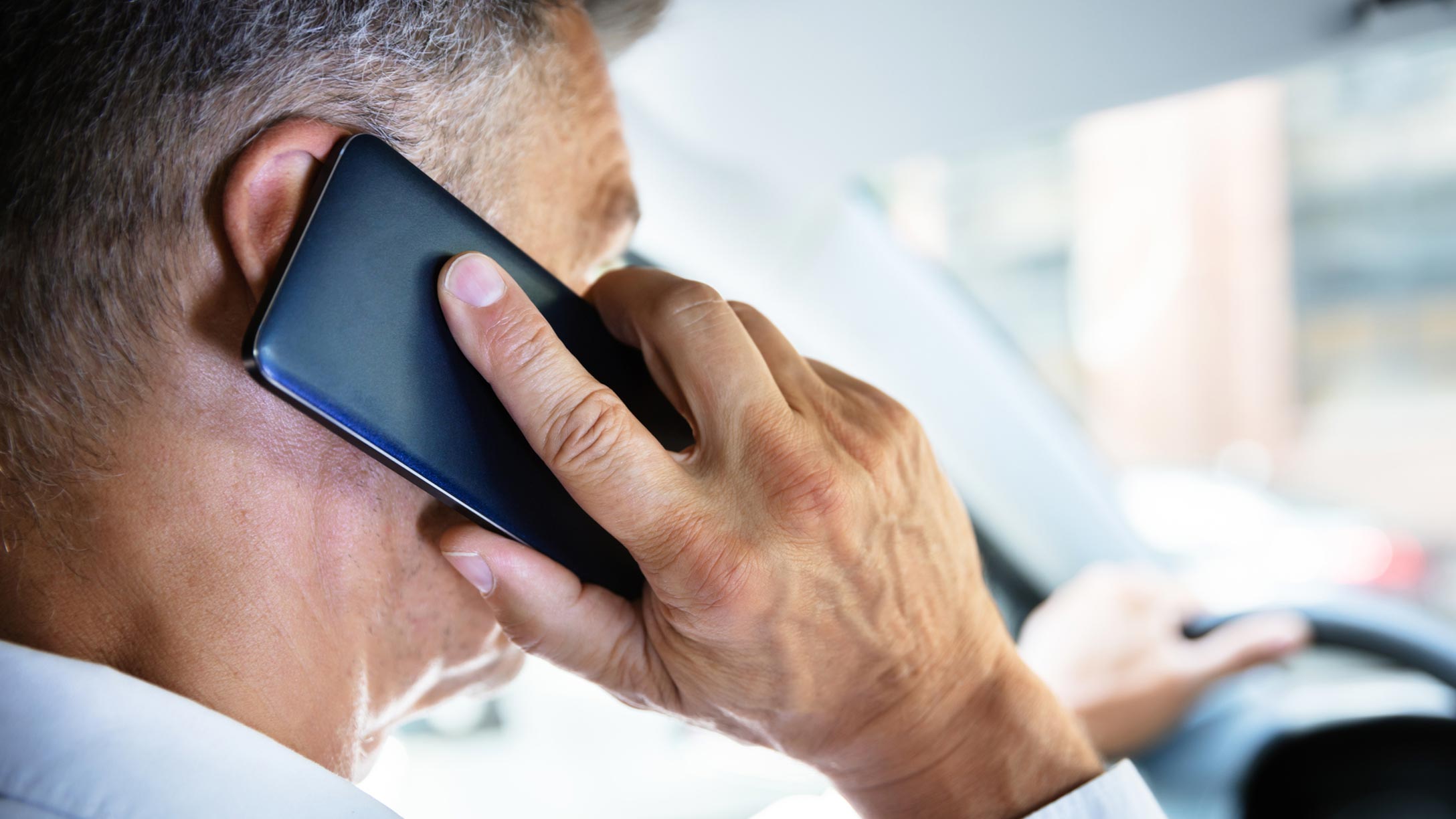 Person on a phone in the car.