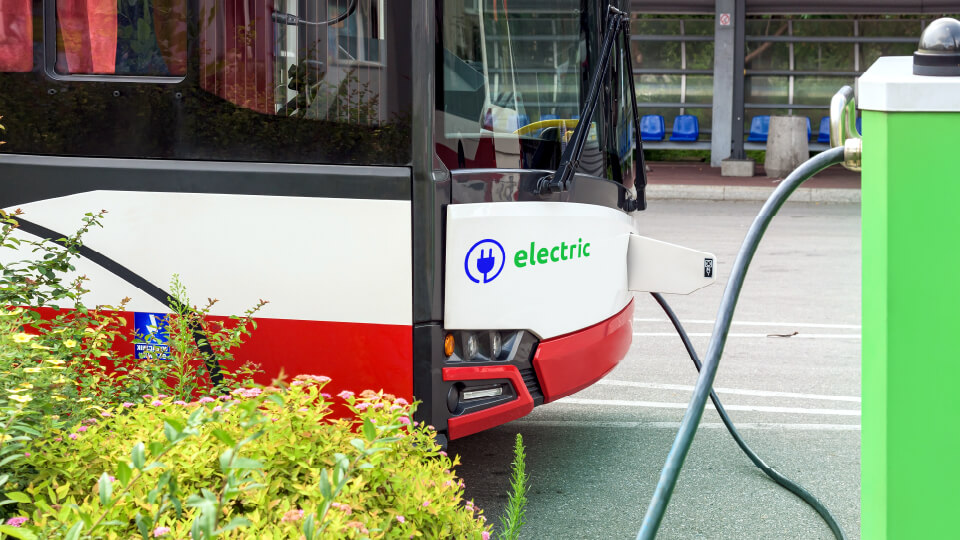 Electric bus being charged at a charging station