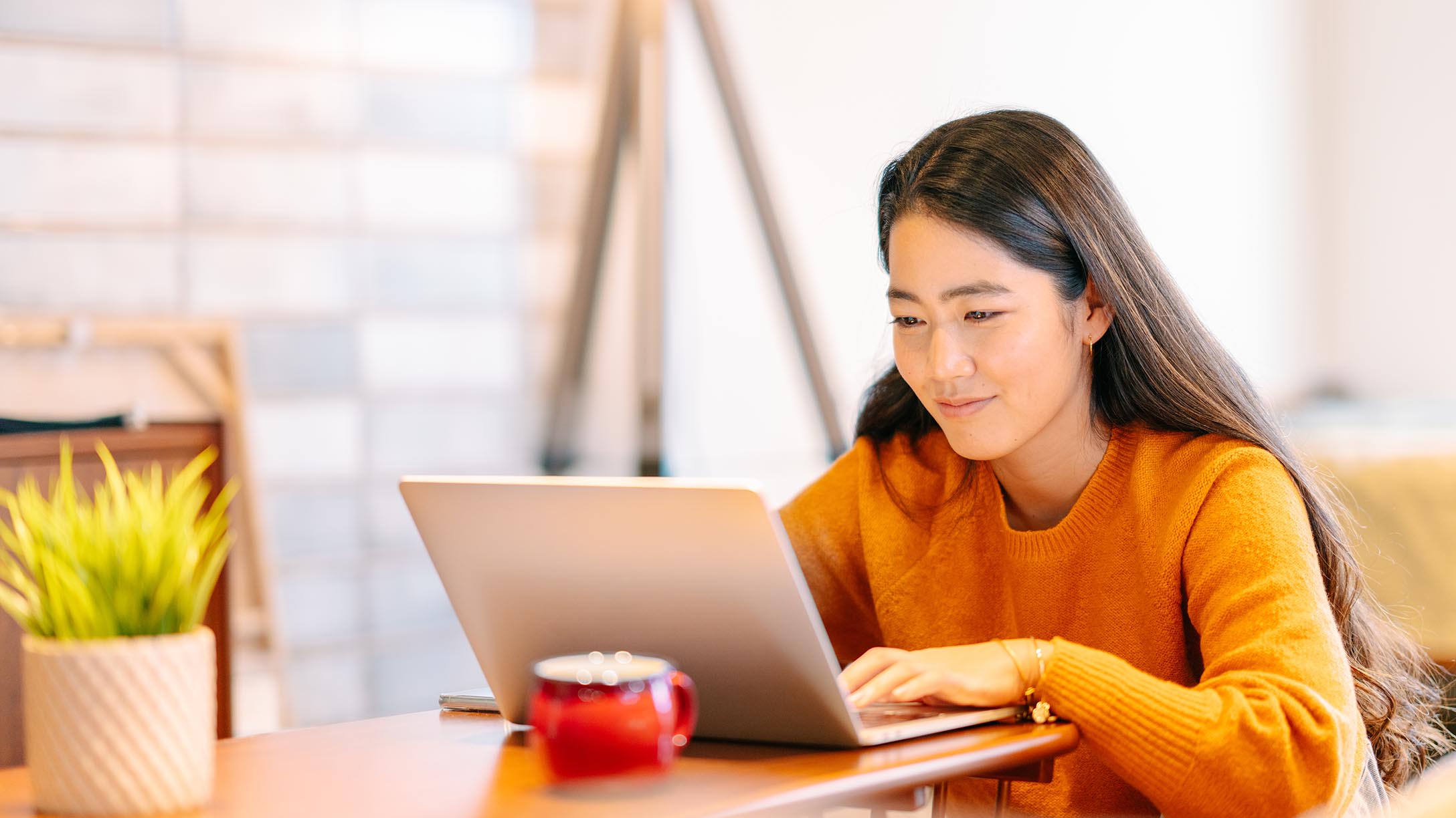 A girl looking at her laptop and working