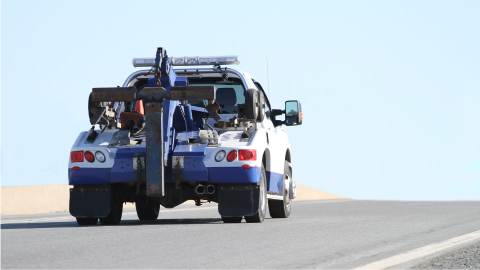 tow truck driving down empty road