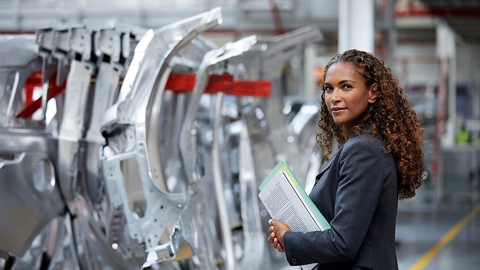 A woman standing in front of car equipment.
