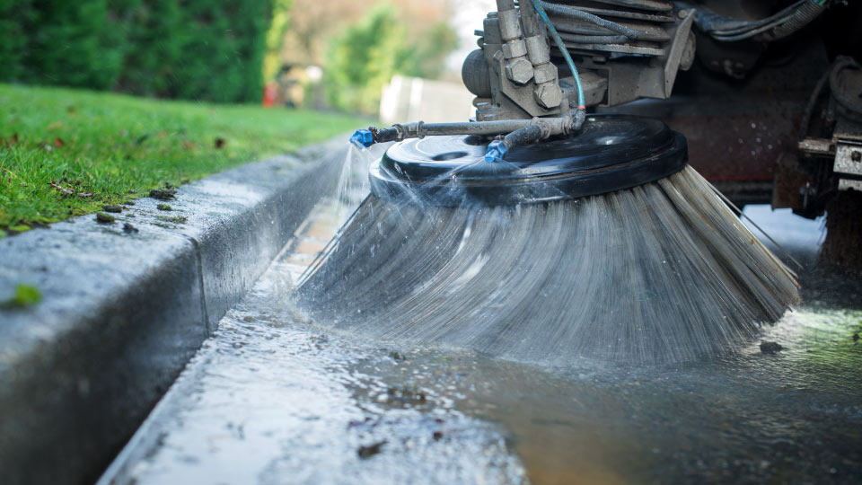 A street brush cleaning the road