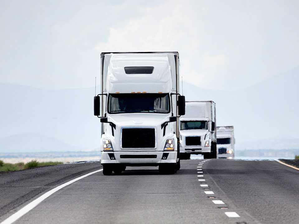 white truck driving down highway