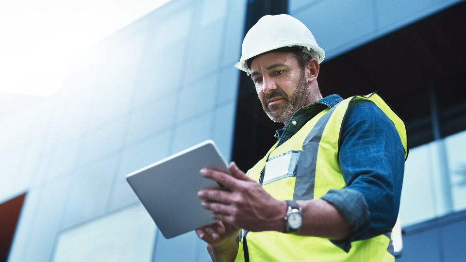 man holding tablet doing work