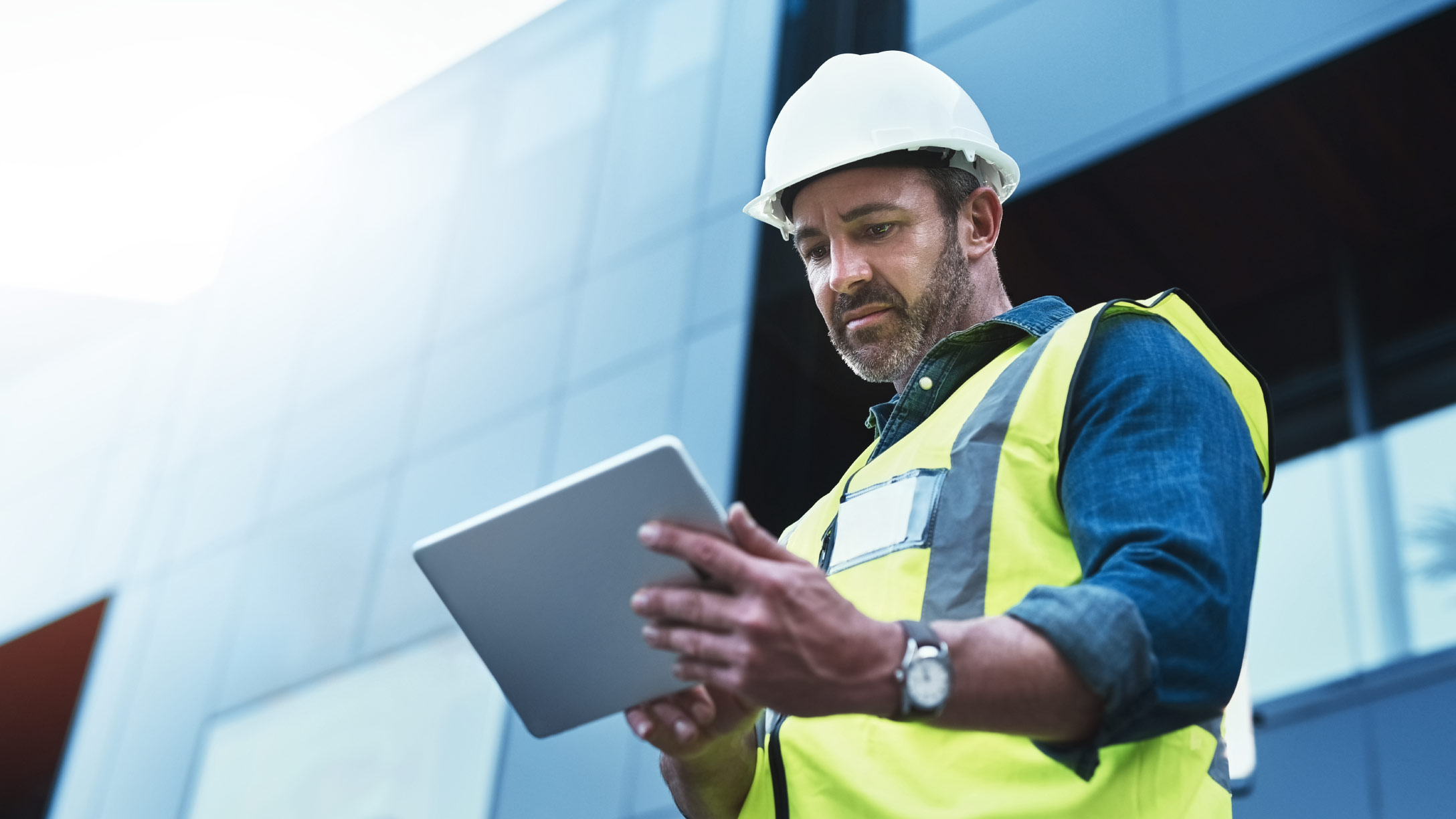 man holding tablet doing work