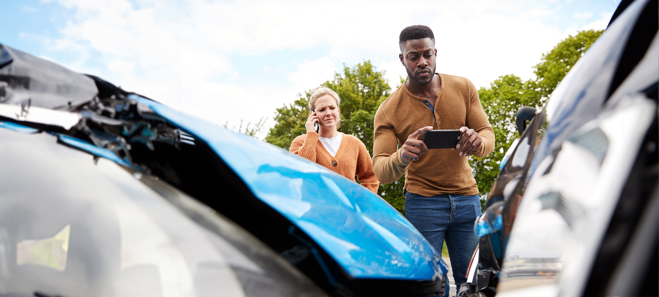 person taking a picture of a collision of two vehicles