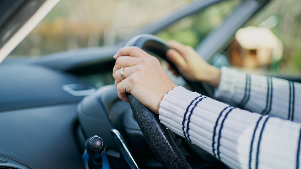 Hands on a steering wheel