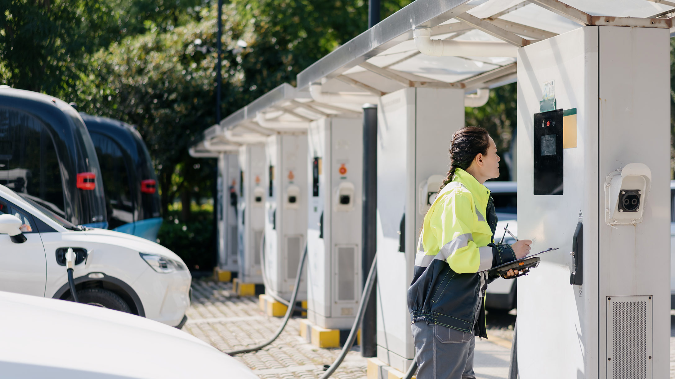 person plugging in an ev to a charger