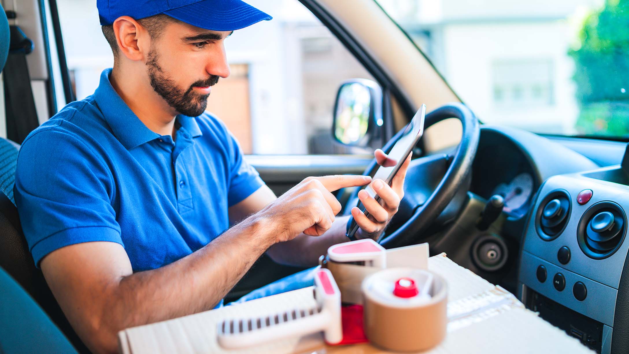 Driver sitting in the drivers seat of a vanv