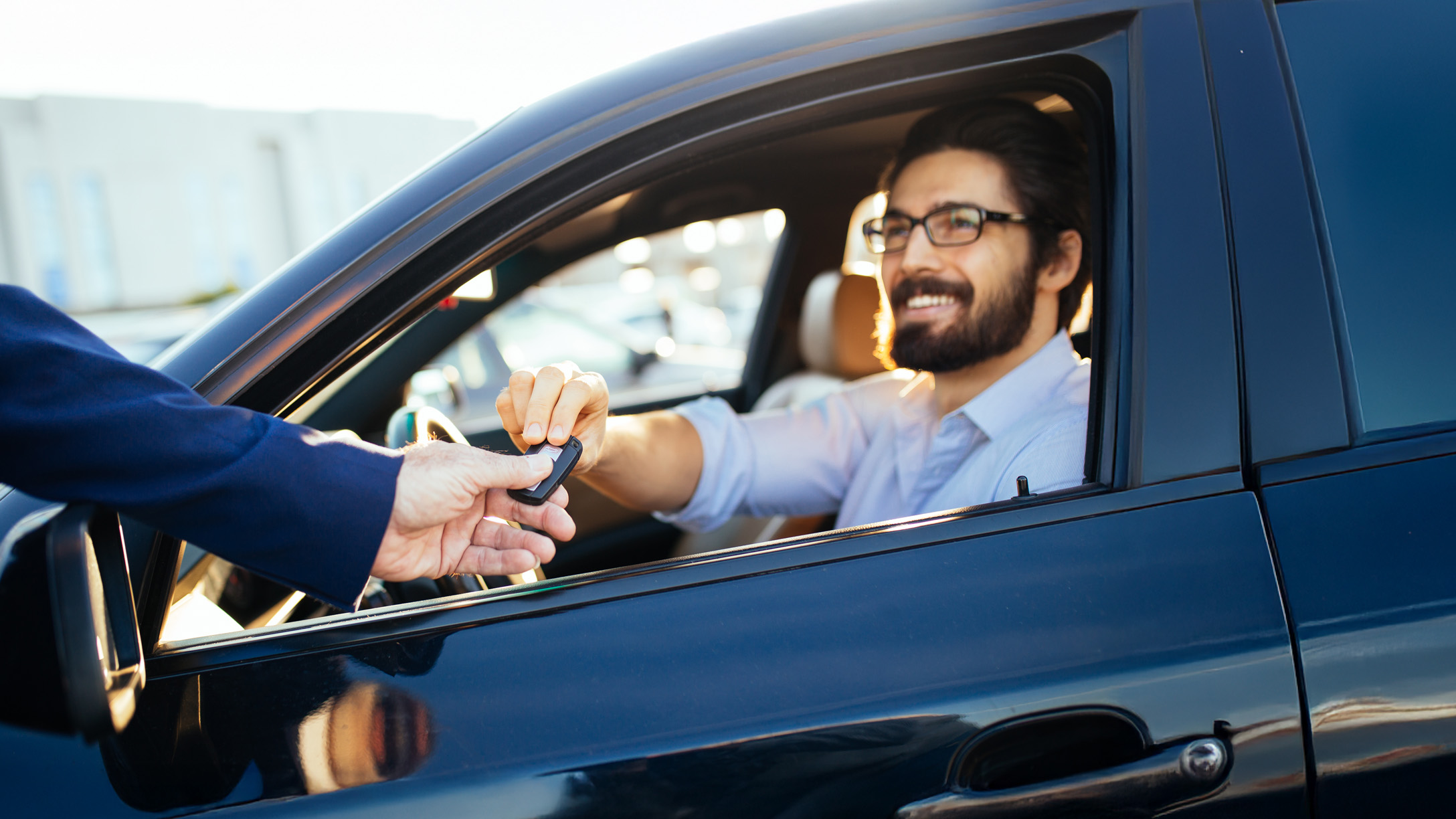 person in car taking keys