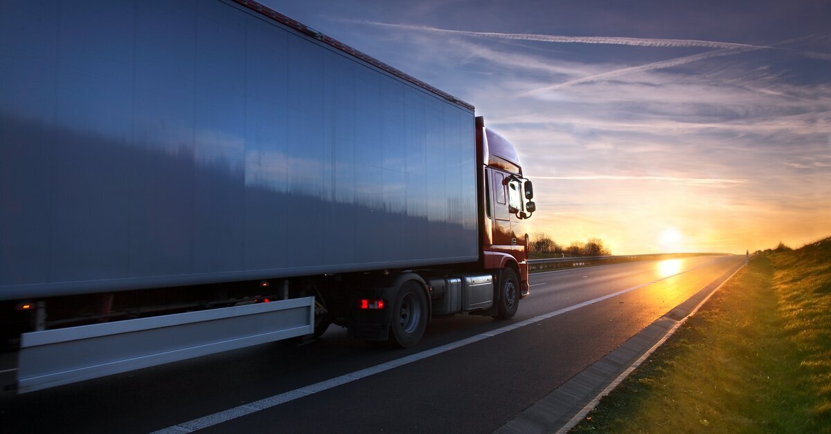 Truck driving on a highway during sunset
