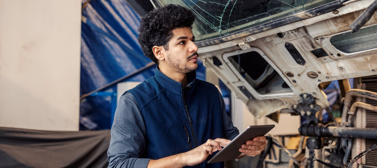 photo of a person on a mobile phone standing next to a truck