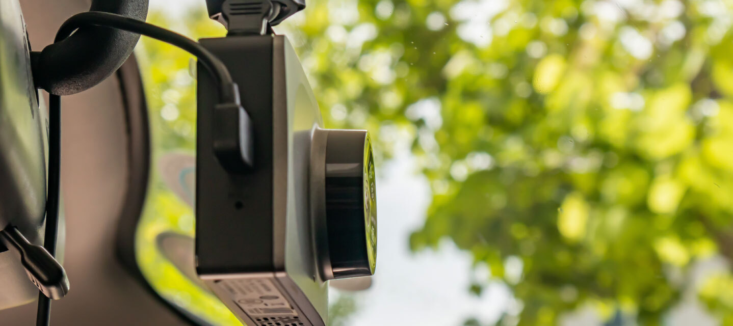 A close up of a fleet camera mounted inside of a fleet truck.