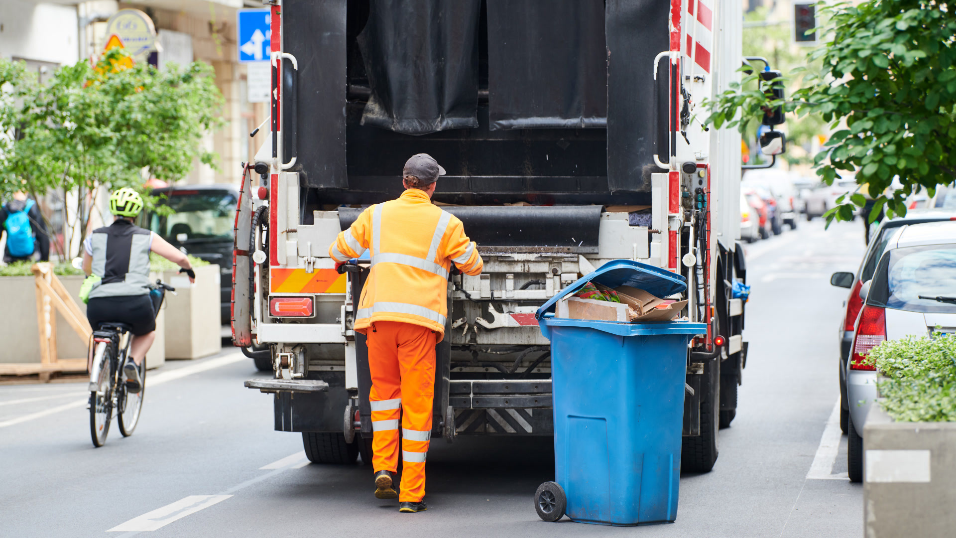 Waste collection truck fitted with AI dash cameras servicing a residential street.