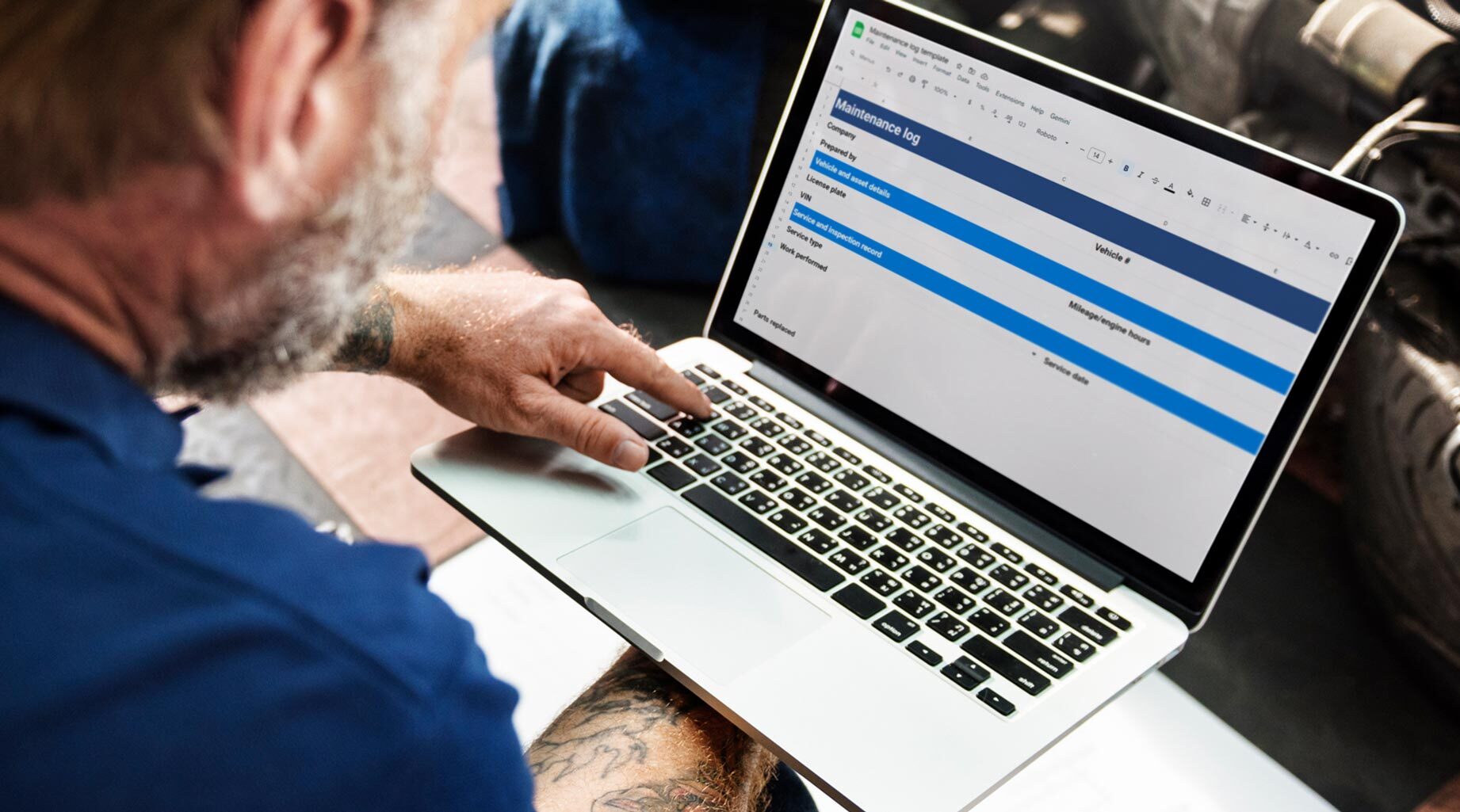 Person using a laptop with a maintenance log spreadsheet template displayed on the screen.