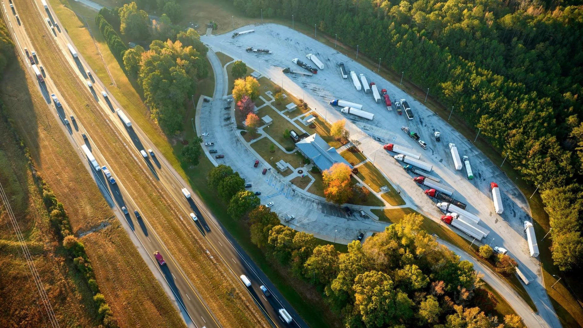 Aerial view of commercial trucks at a highway rest stop in British Columbia