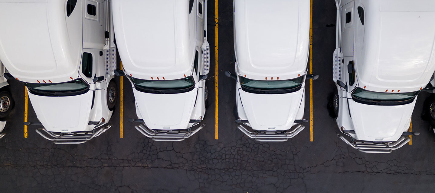 A view of white fleet trucks from an aerial view. 