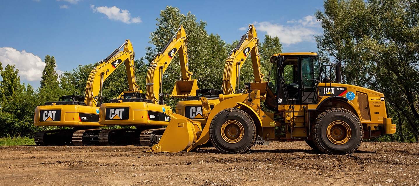 three construction fleet vehicles outside. 