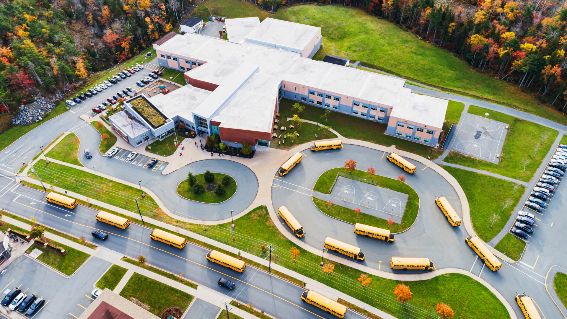 Yellow school bus on a residential street with a dash cam view of the road ahead