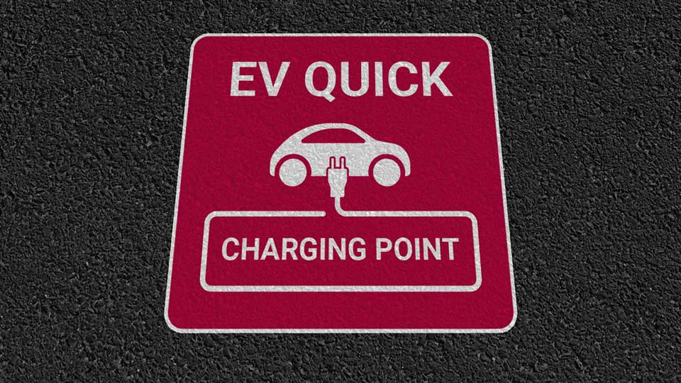 Red sign that says 'EV QUICK Charing Point' with electric vehicle icon