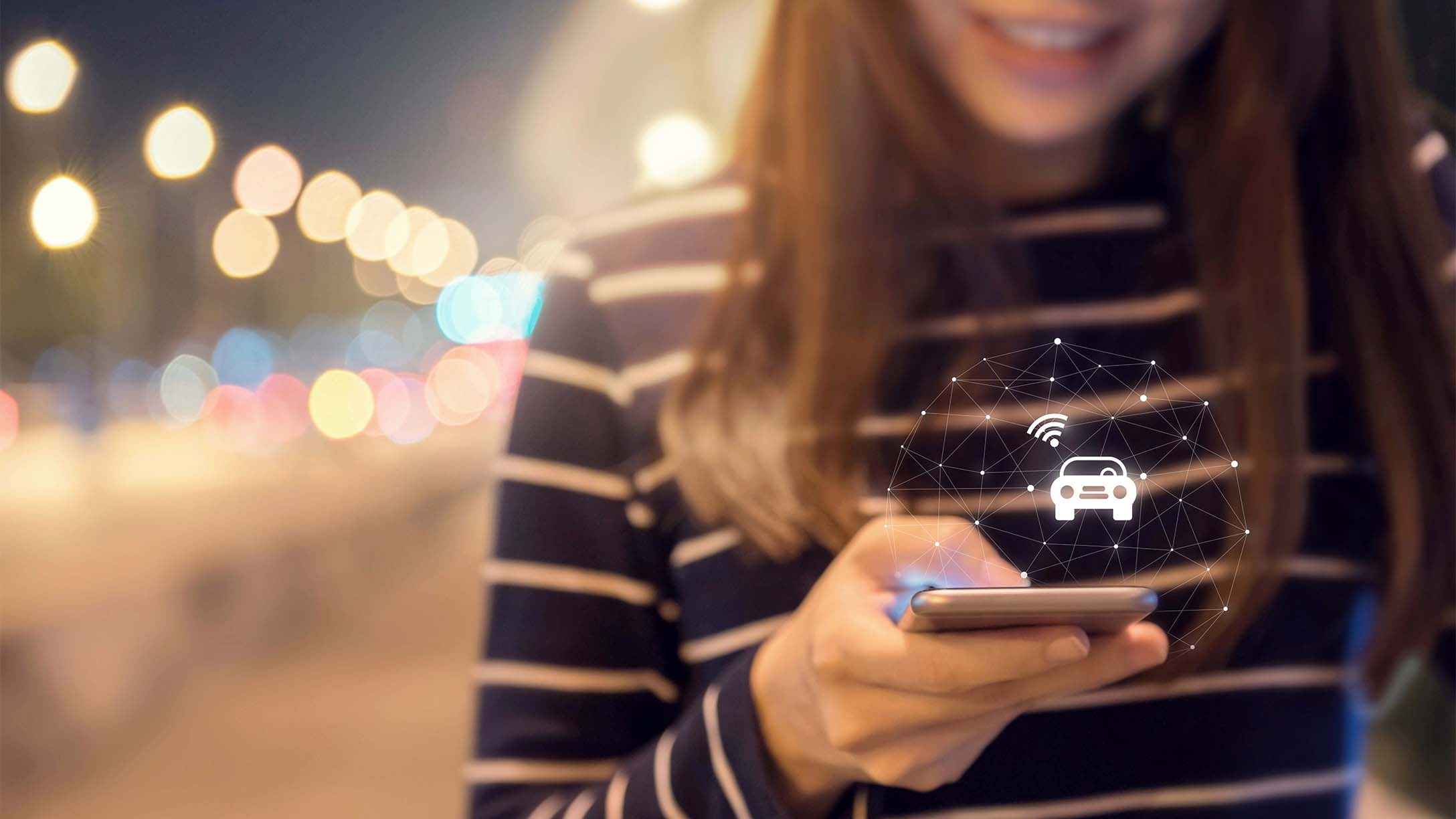 Woman using phone with white car sharing icon hovering over the phone