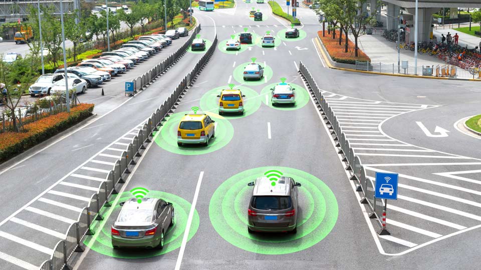 Vehicles driving on road with green circle under each one of them