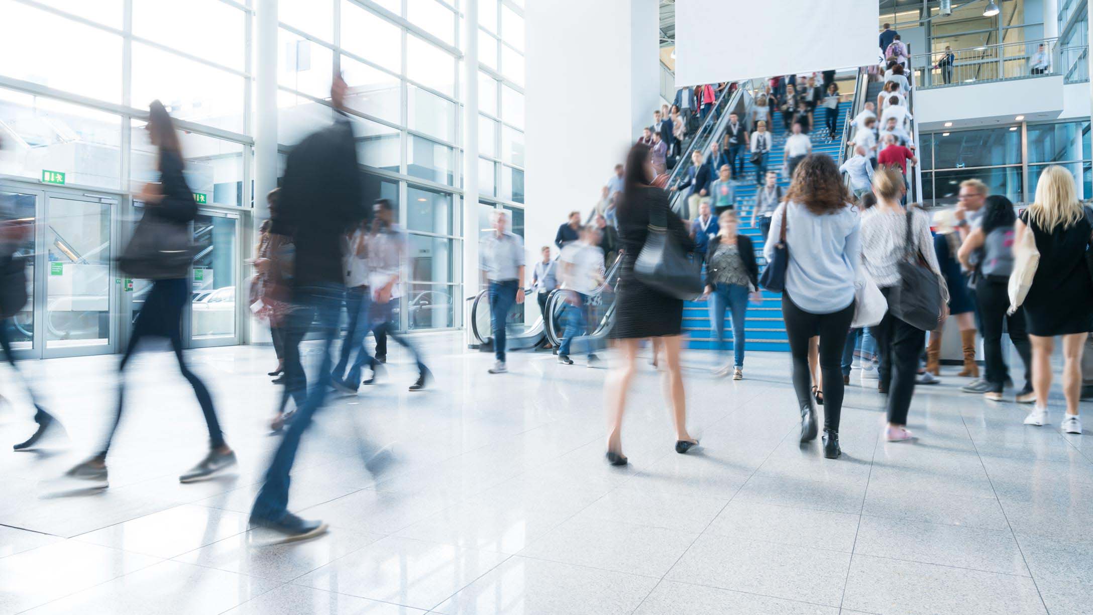 People walking inside of a busy building