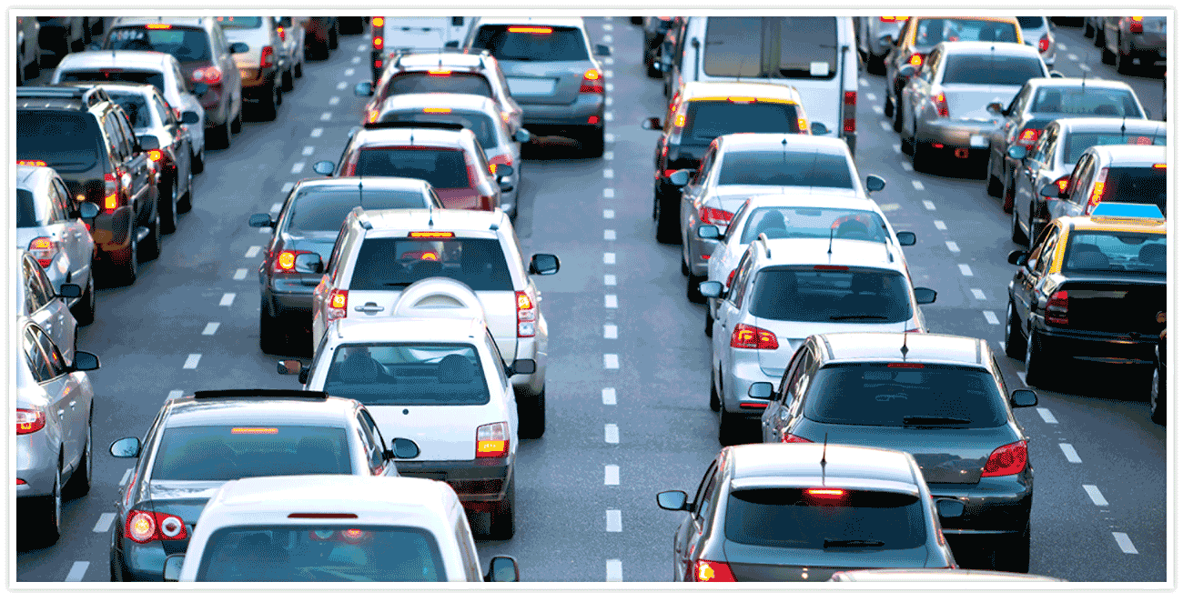 A wide variety of vehicles backed up in multiple lanes on a highway 