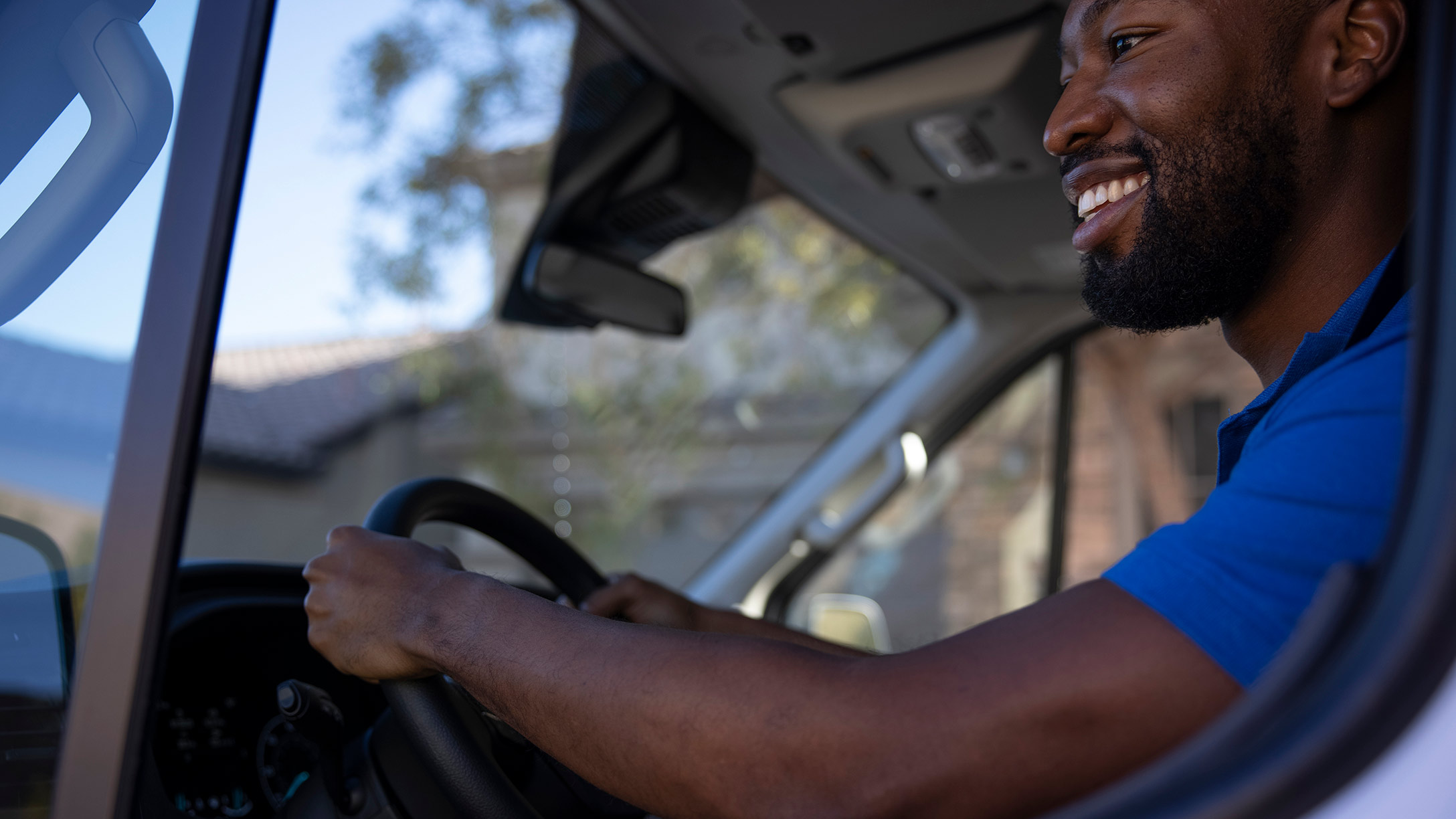 A man holding a steering in a truck