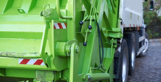 Back of a lime green garbage truck