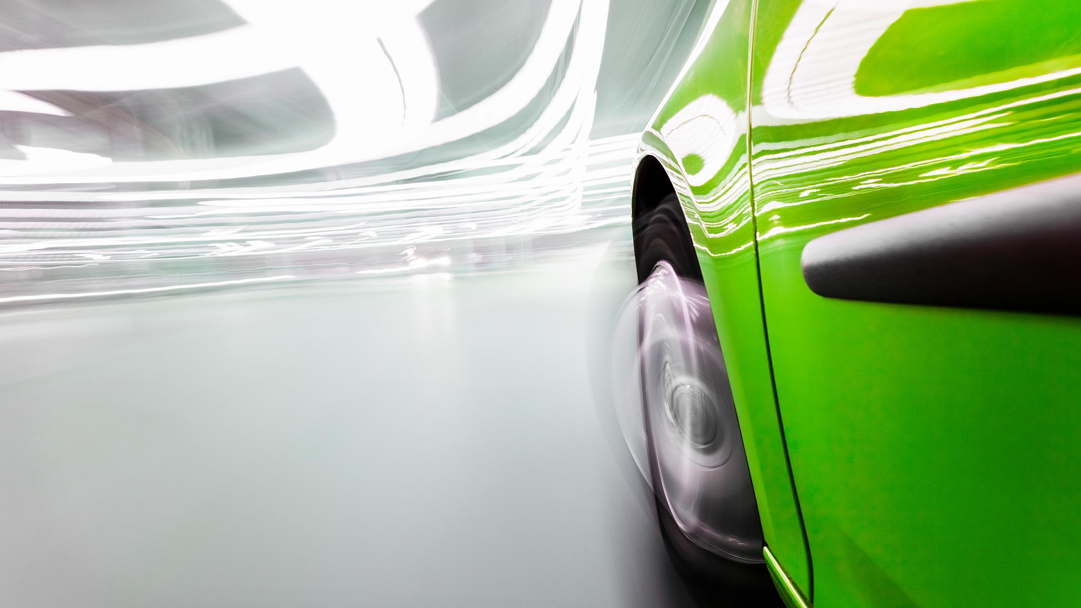 Side view of a green car in an indoor space