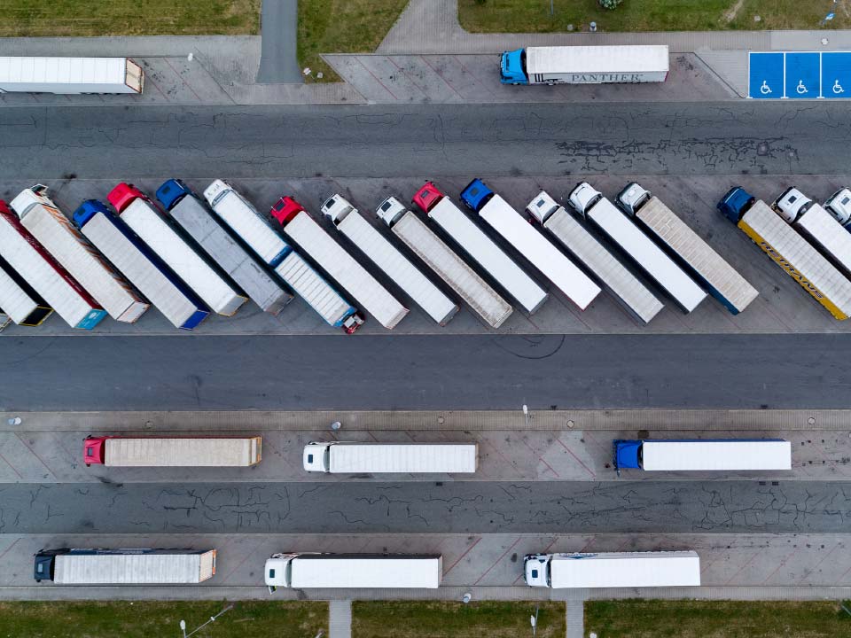 A picture of trucks parked in a parking spot. 