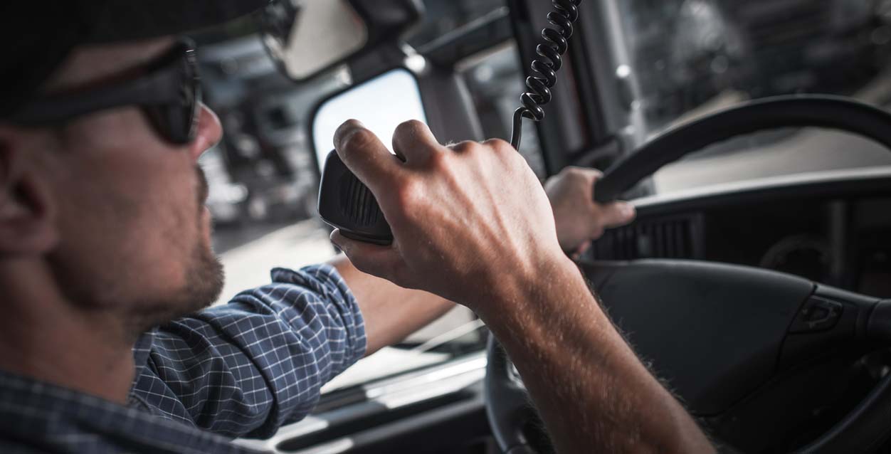 A man using the radio in his semi truck