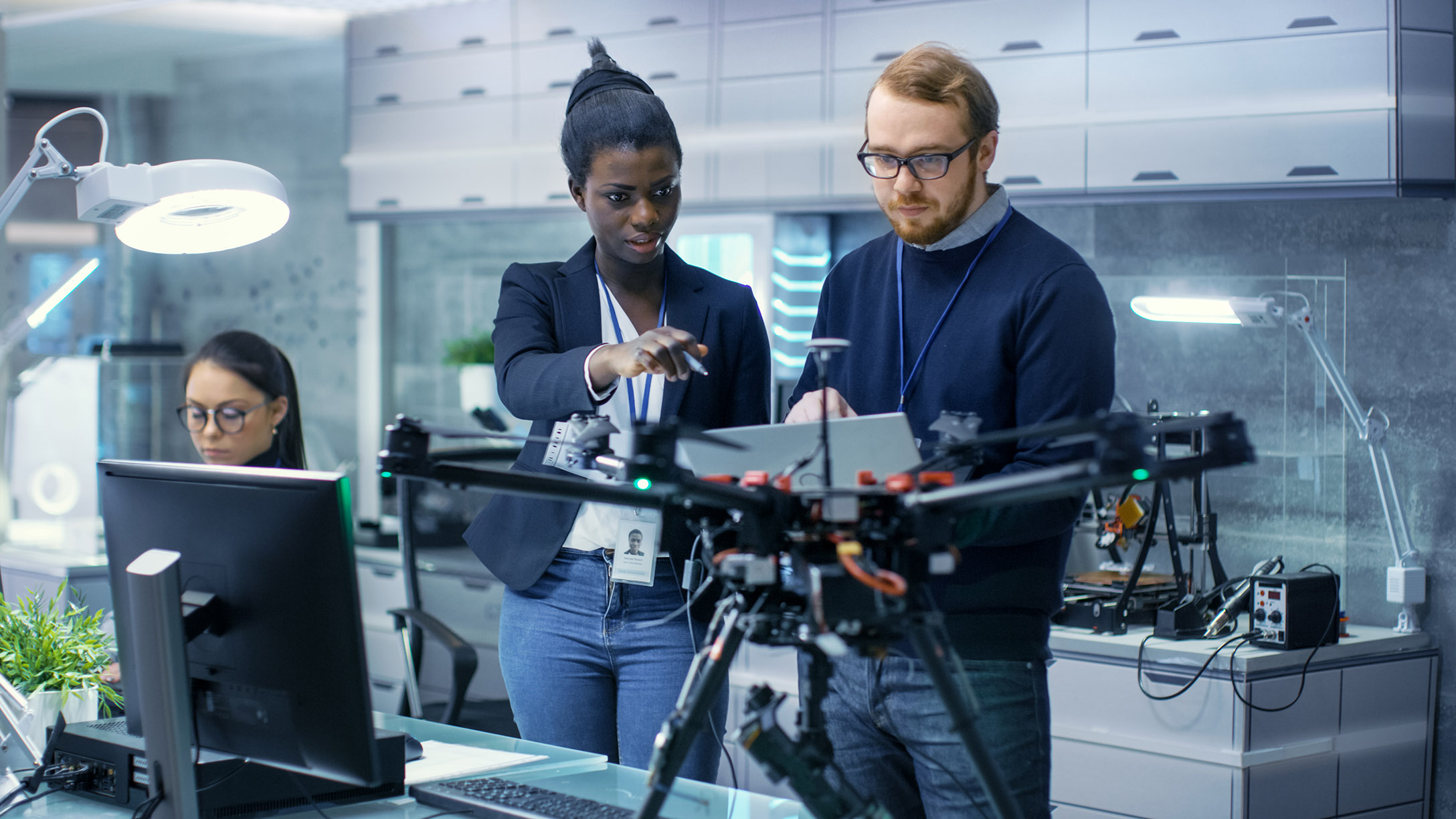 A lady and man talking with equipment around them.