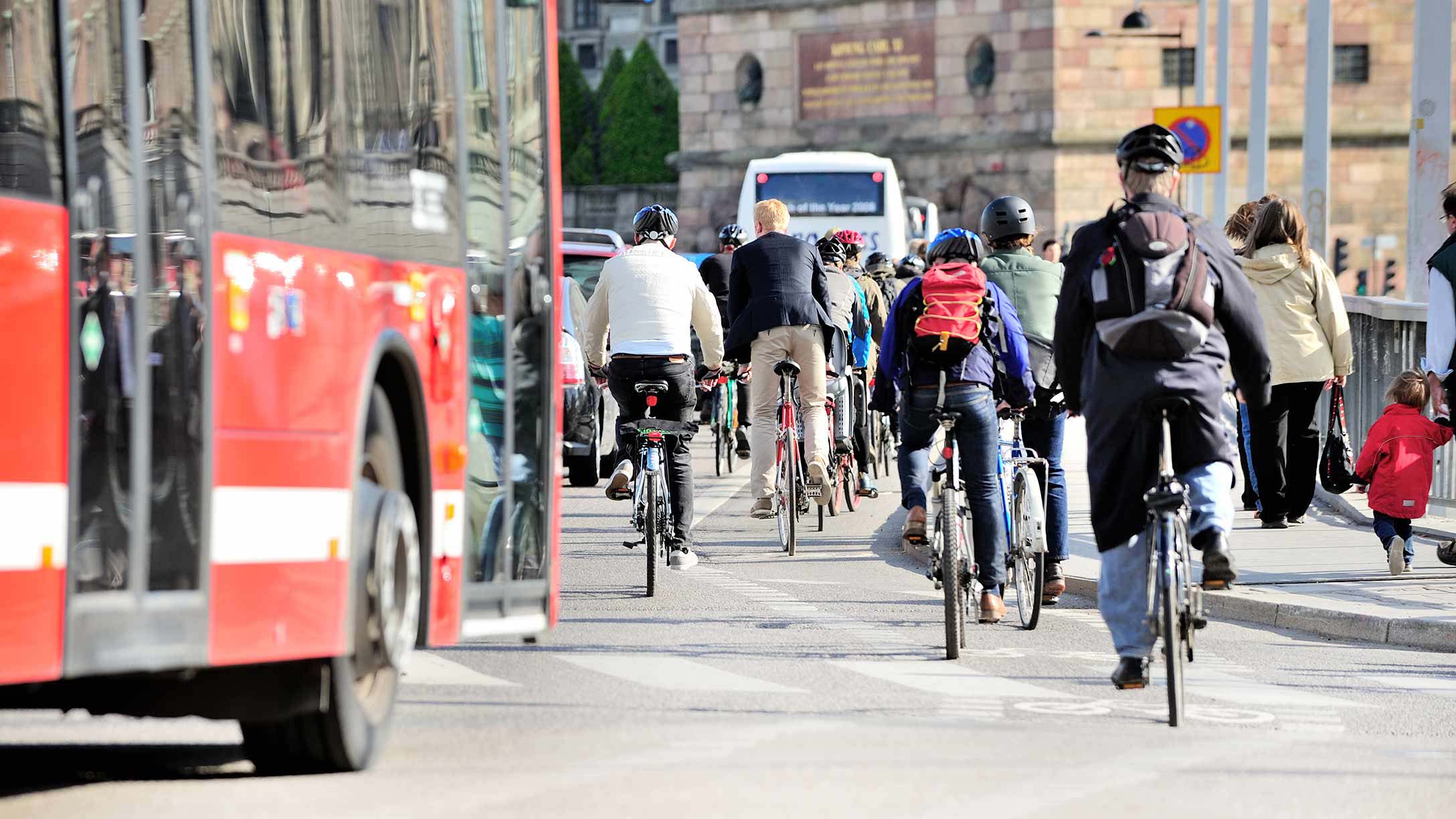 People riding bikes on a busy city street