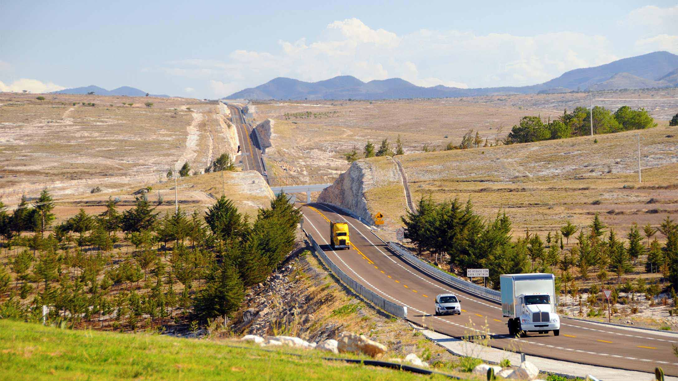 Vehicles driving on a road during day time