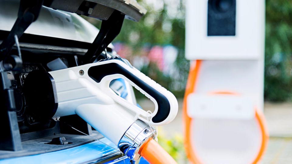 Electric vehicle being charged at a electric vehicle charge station