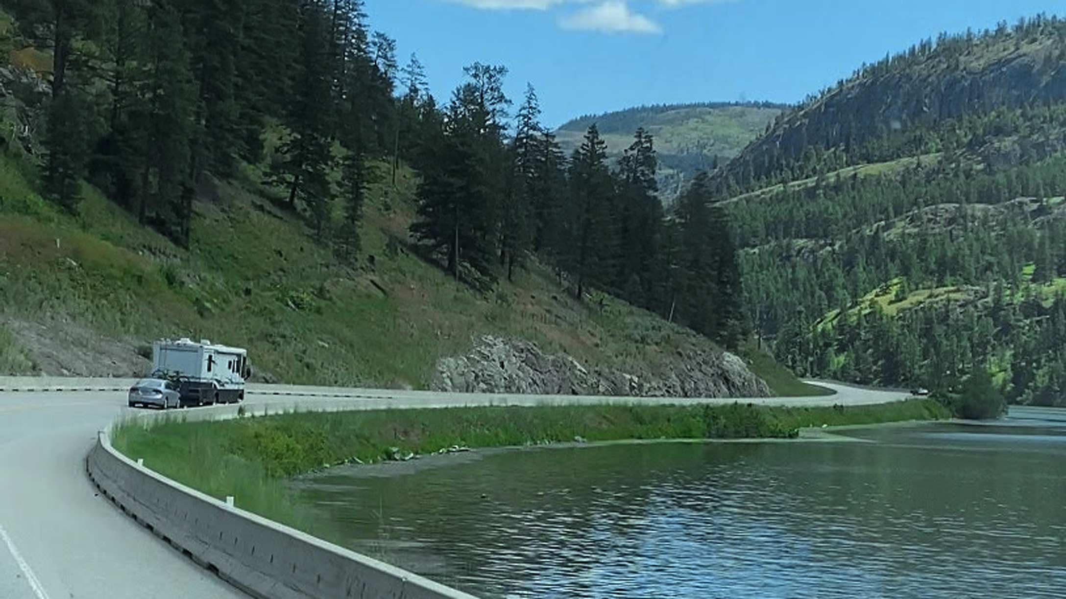 Truck and car driving on road