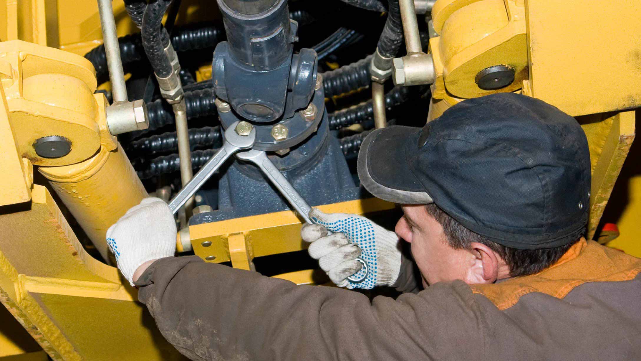 Person doing heavy equipment maintenance