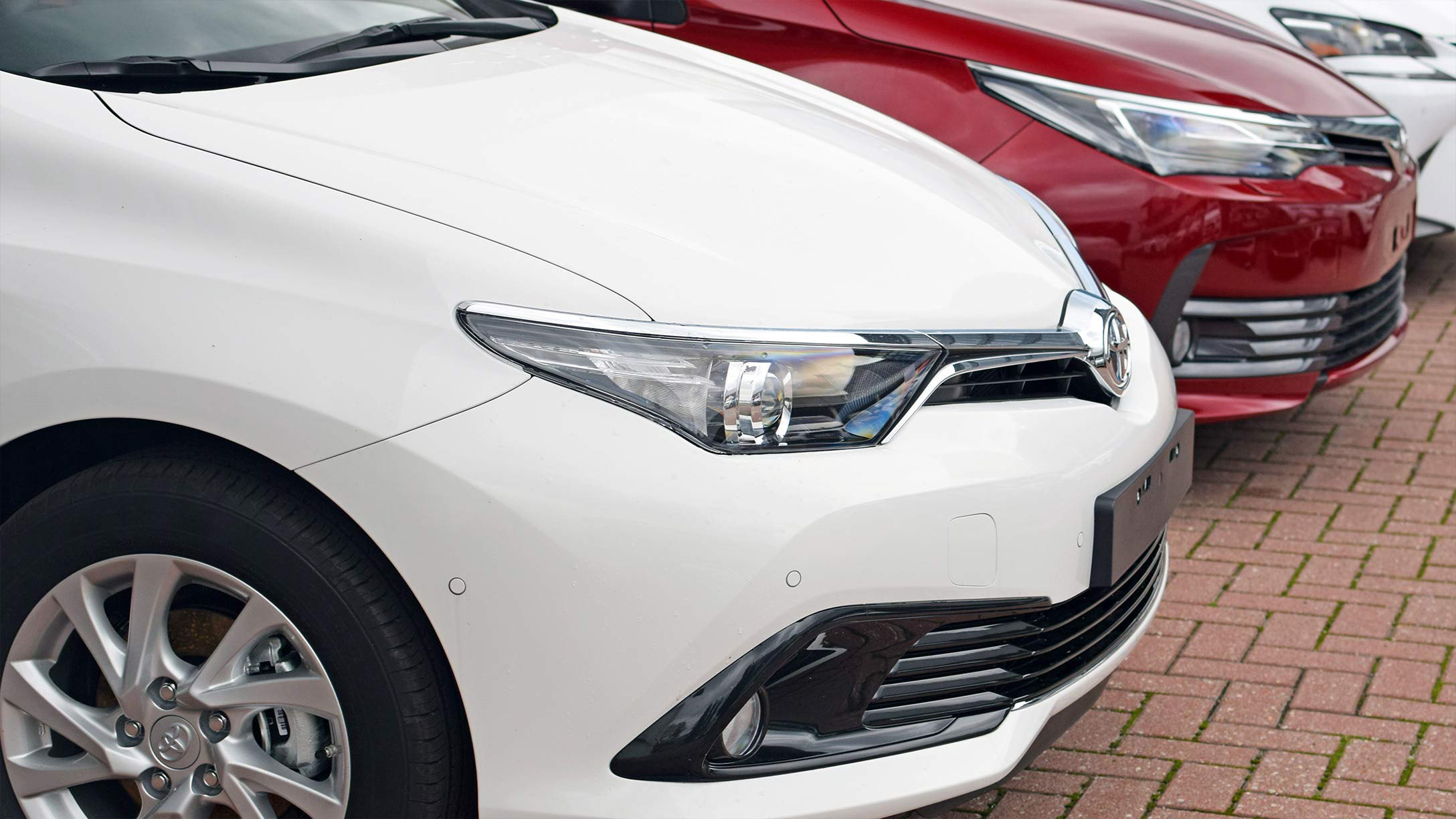 White and red car parked beside each other