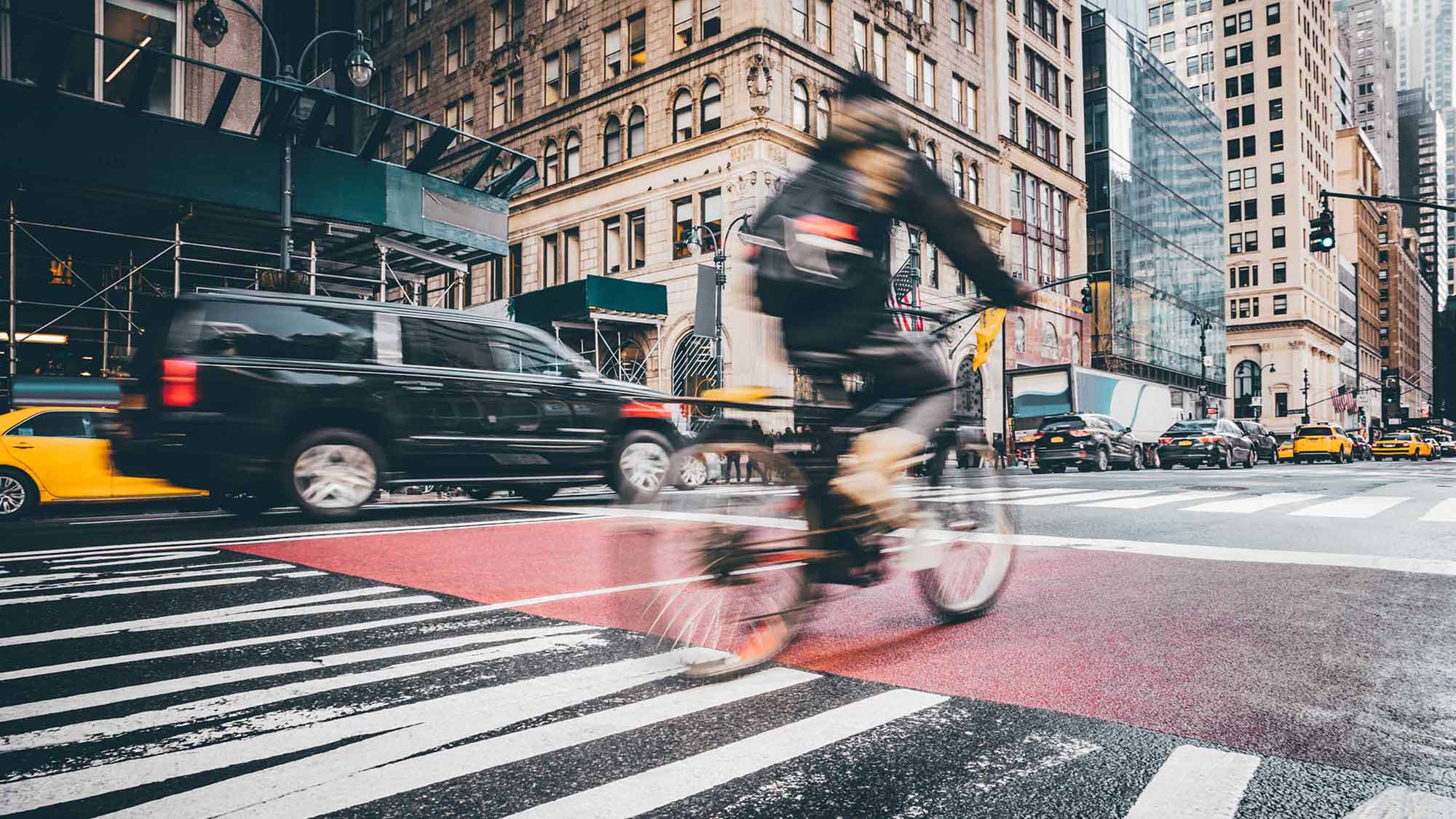 Person biking on busy street