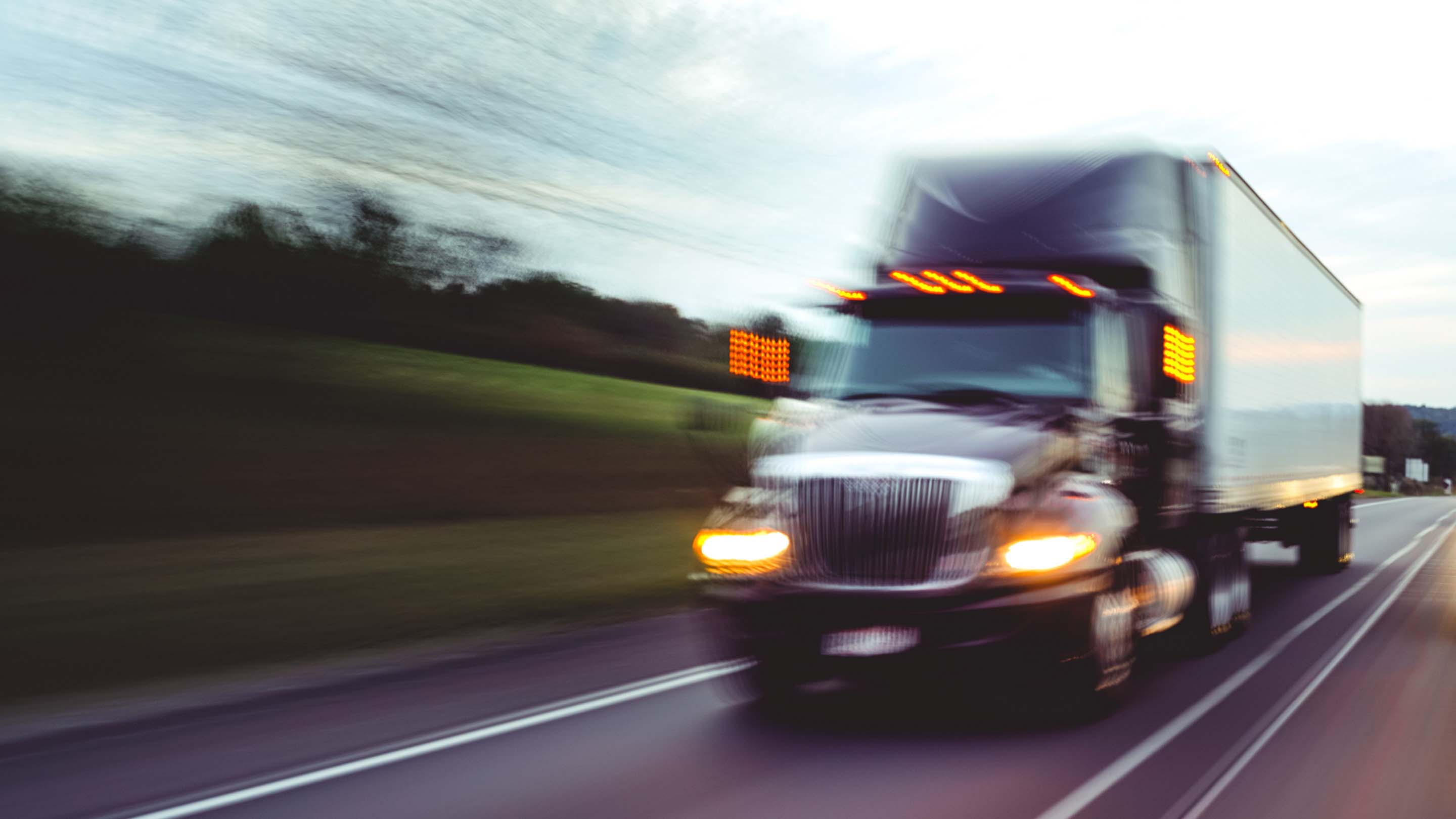 Blurry image of truck speeding down the road