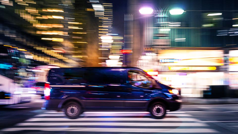 Van driving on road during night time