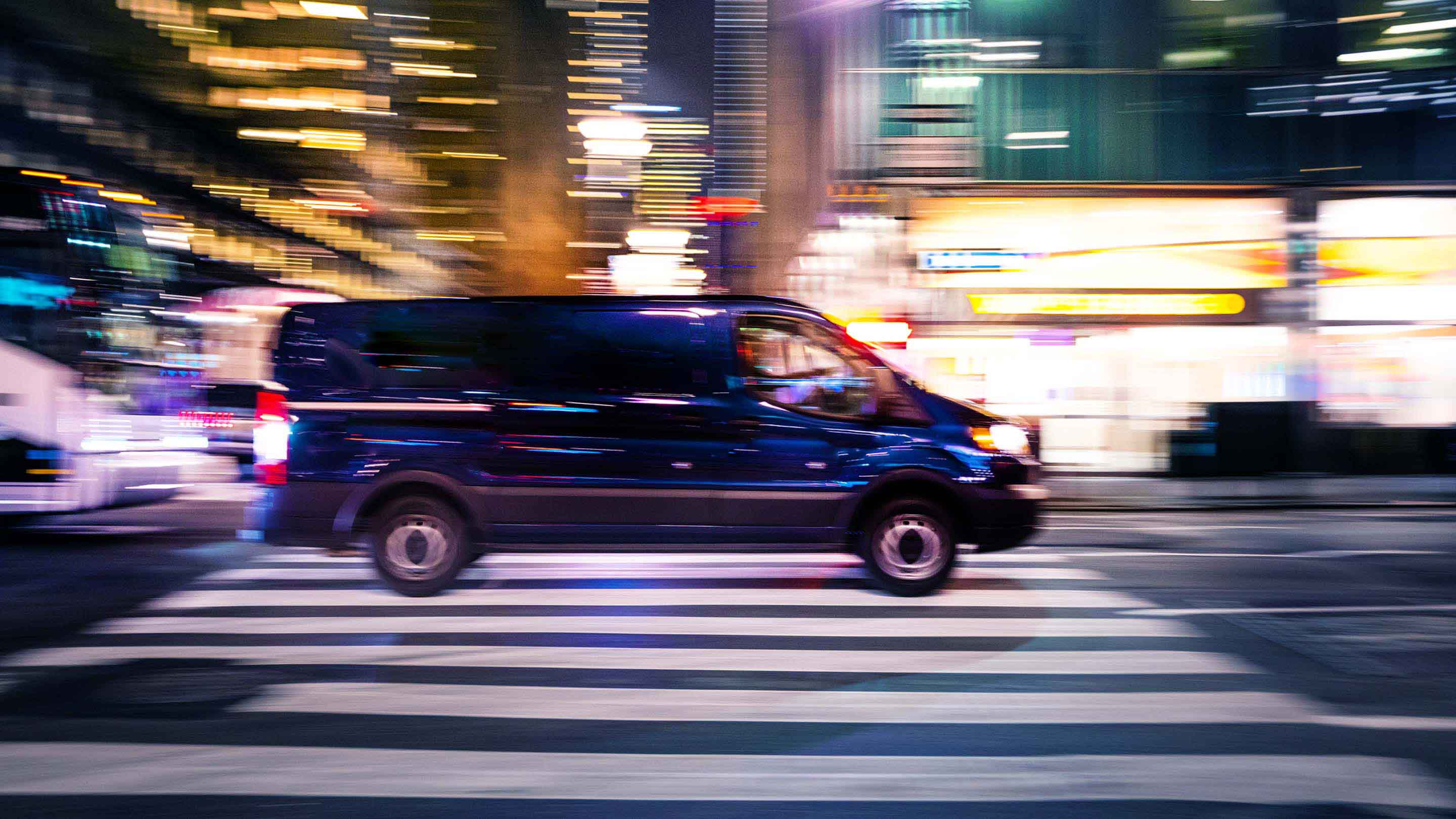 Van driving on road during night time