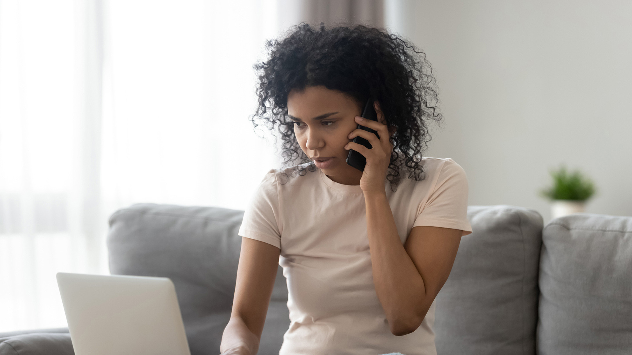 Woman on the phone and computer looking for a job