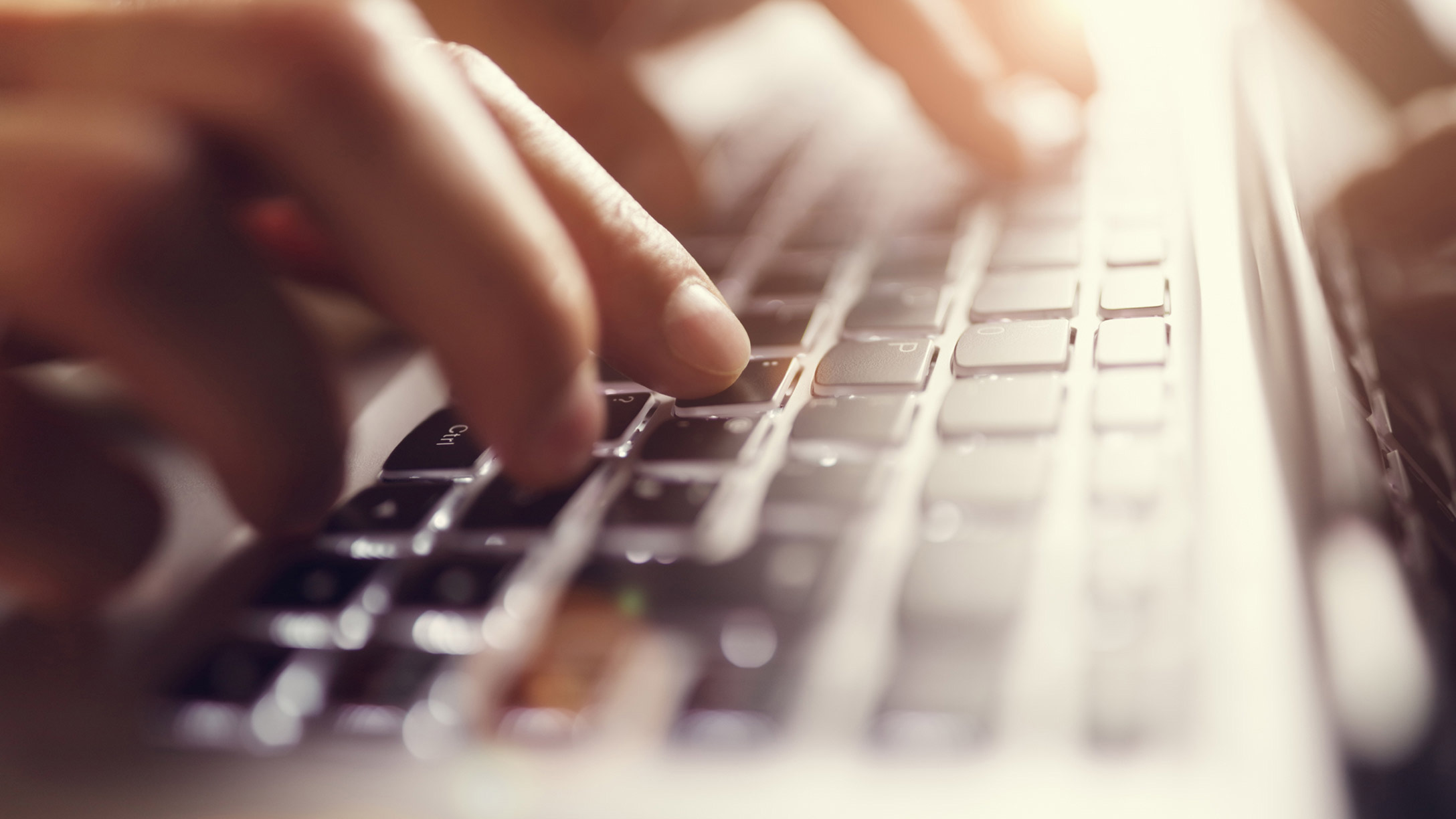 Hands typing on a keyboard