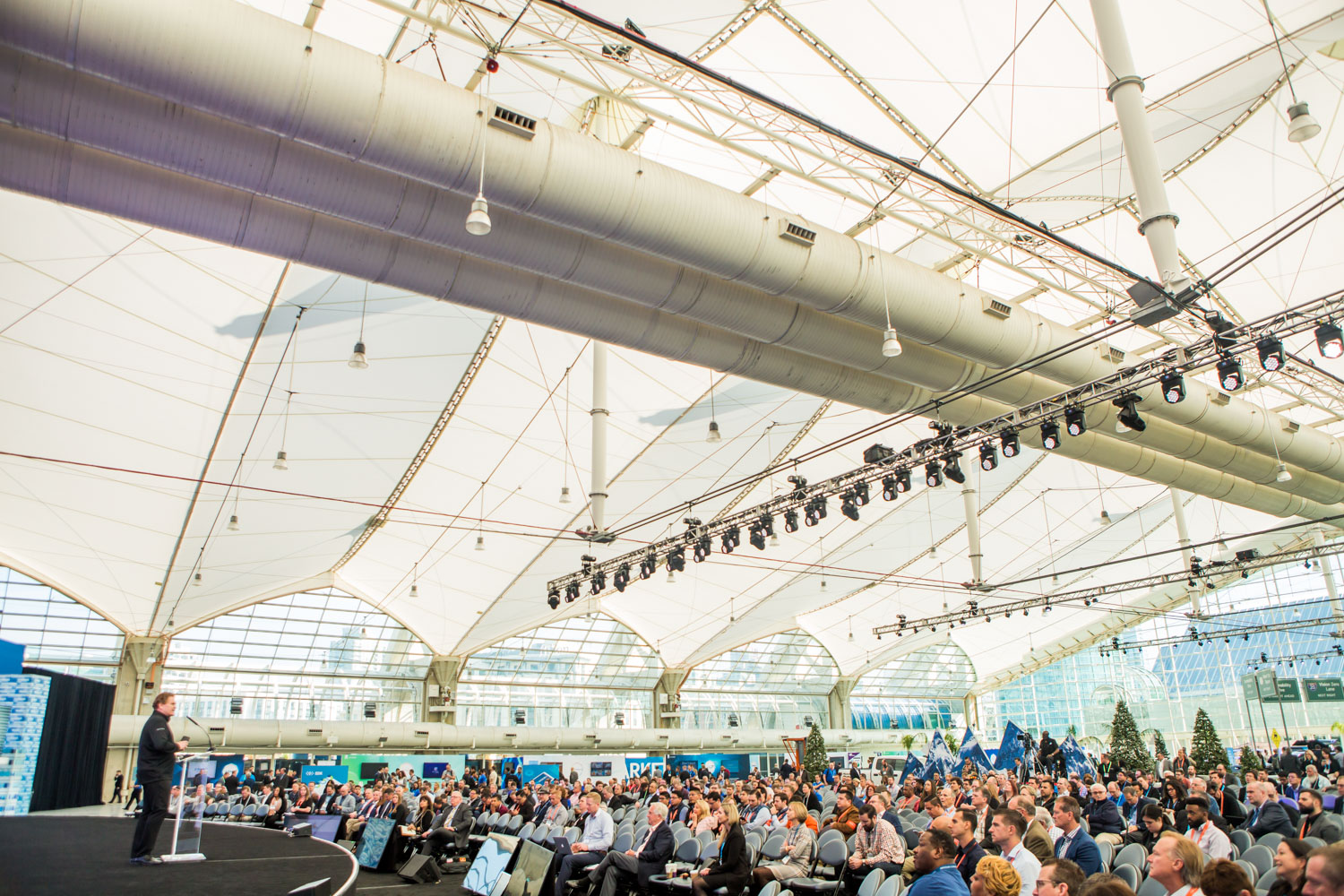 A crowd of people watching a speech 